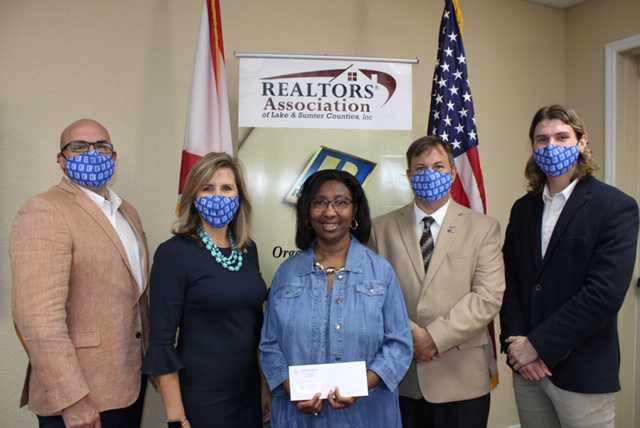 Mollie Cunningham accepts a campaign donation from the Lake County Realtors Association
