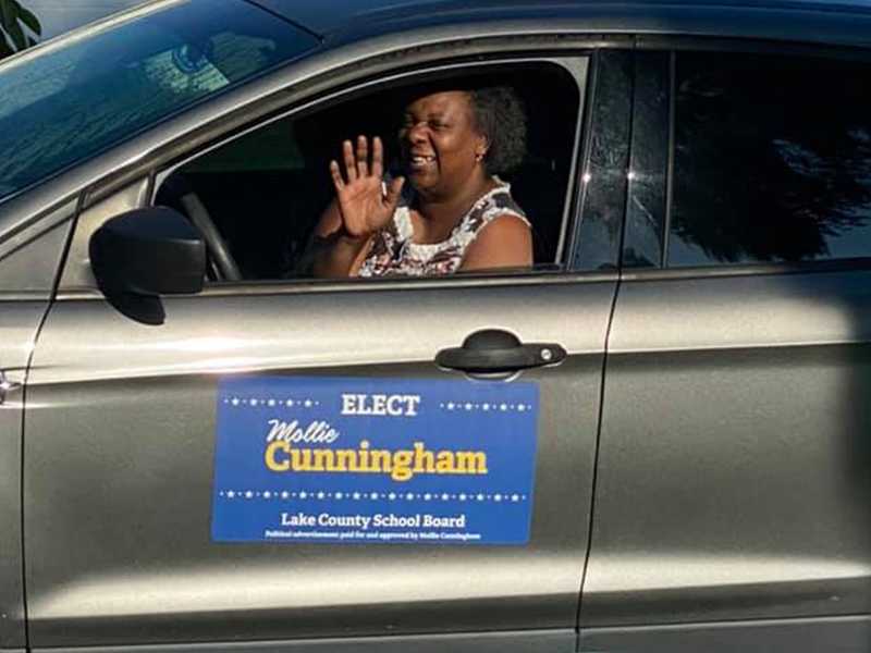 Local resident Pam Simmons driving a car with an advertisement for Mollie's campaign on the door